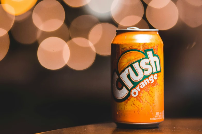 a can of crush orange sitting on a wooden table