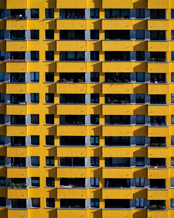 a multicolored apartment building with lots of windows