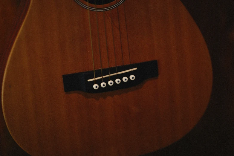 the frets of a guitar are visible with the string on