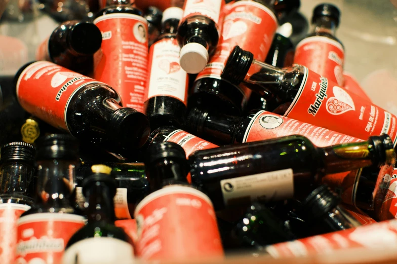 a pile of red and white bottles stacked together