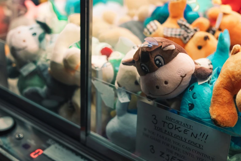 various colored stuffed animals in a display case