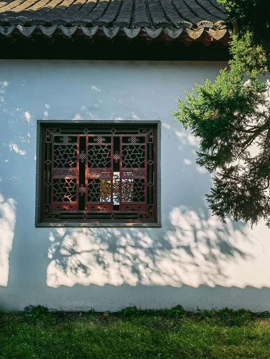 a white wall with a window and red windows