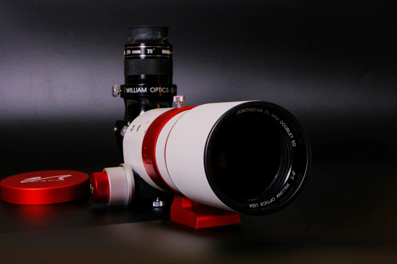 a red and white lens sitting on top of a table