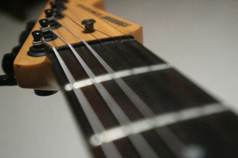 an electric guitar neck that is almost a real acoustic instrument