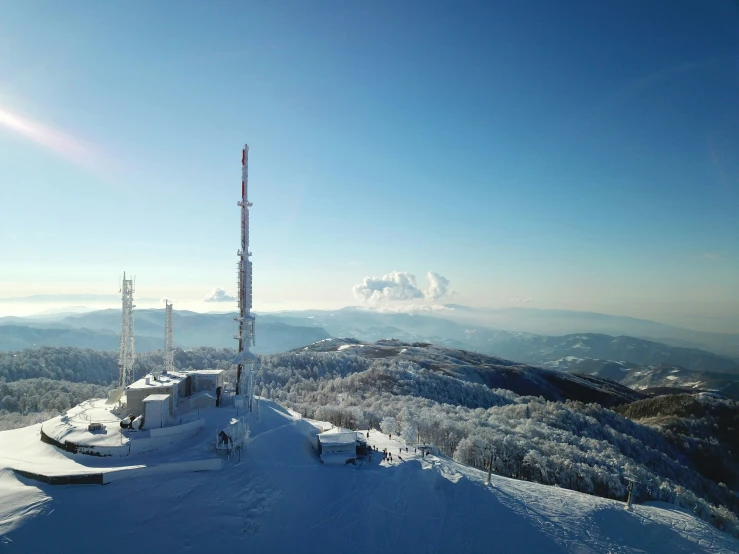 the sun shines brightly over the snow covered mountains