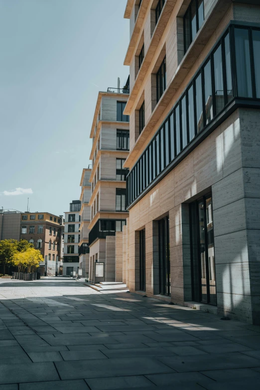 an empty street is full of brown building