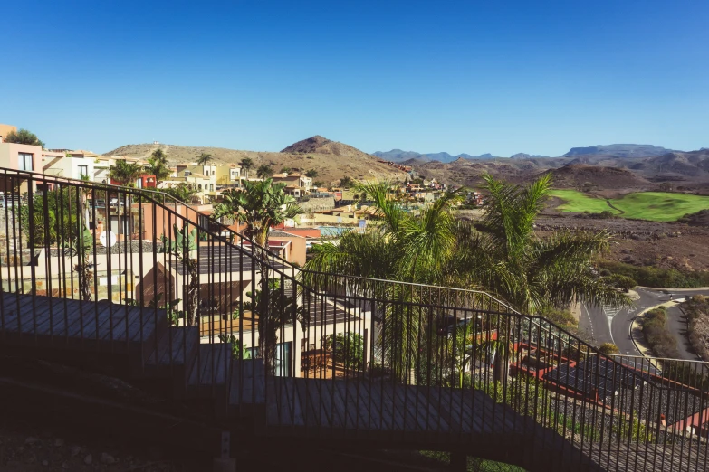 looking down a street, toward a city with mountains