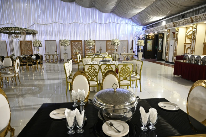 a fancyly decorated banquet hall with tables and chairs