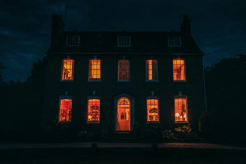 an old house lit up at night time