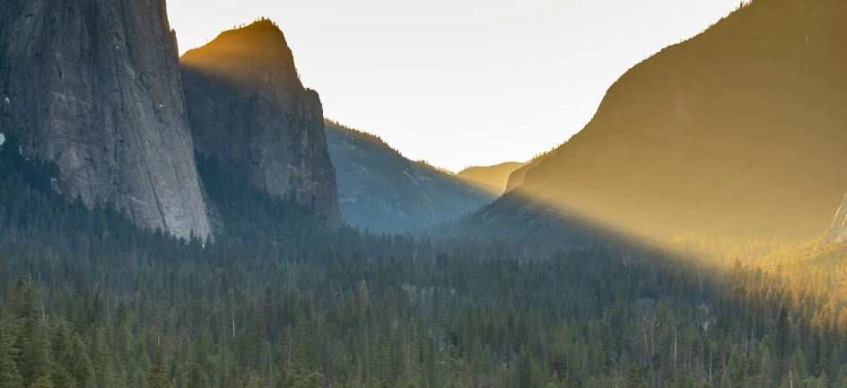 a boat sits on the water by mountains