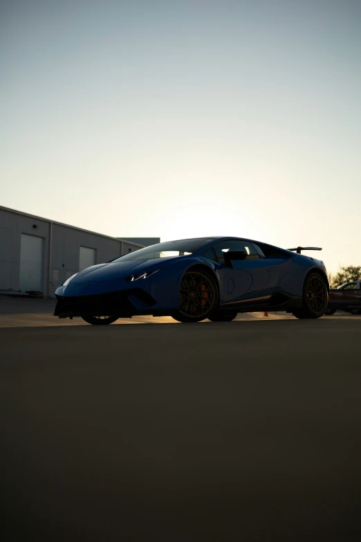 a sports car is parked near an industrial building