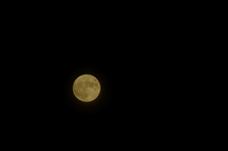 a large moon in a black sky with no clouds