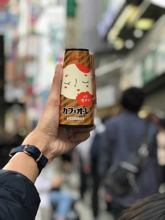 the woman is holding up an old japan drink