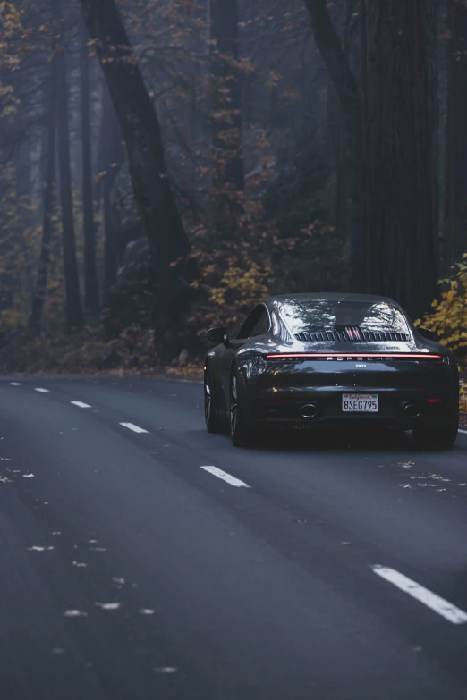 a car parked along a road near trees