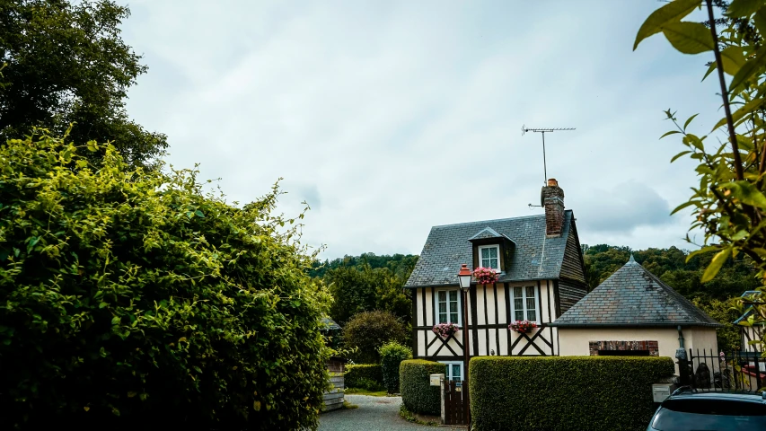 there is a house with a tower near a bush