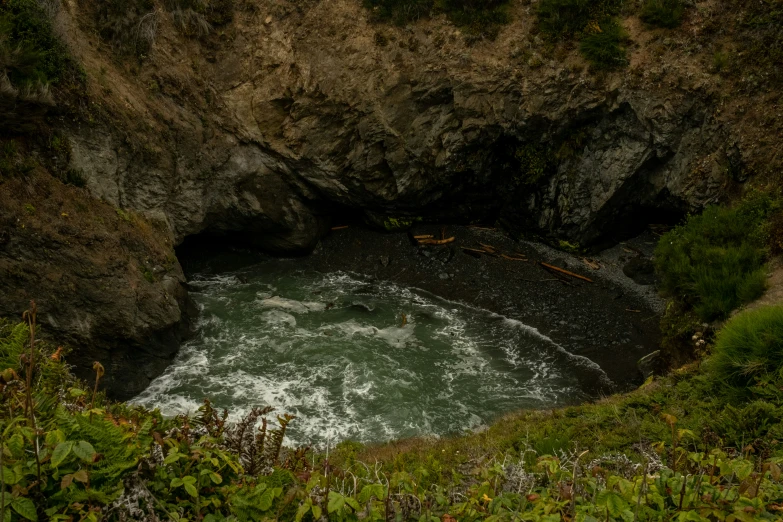 there is a river and some rocks and green grass