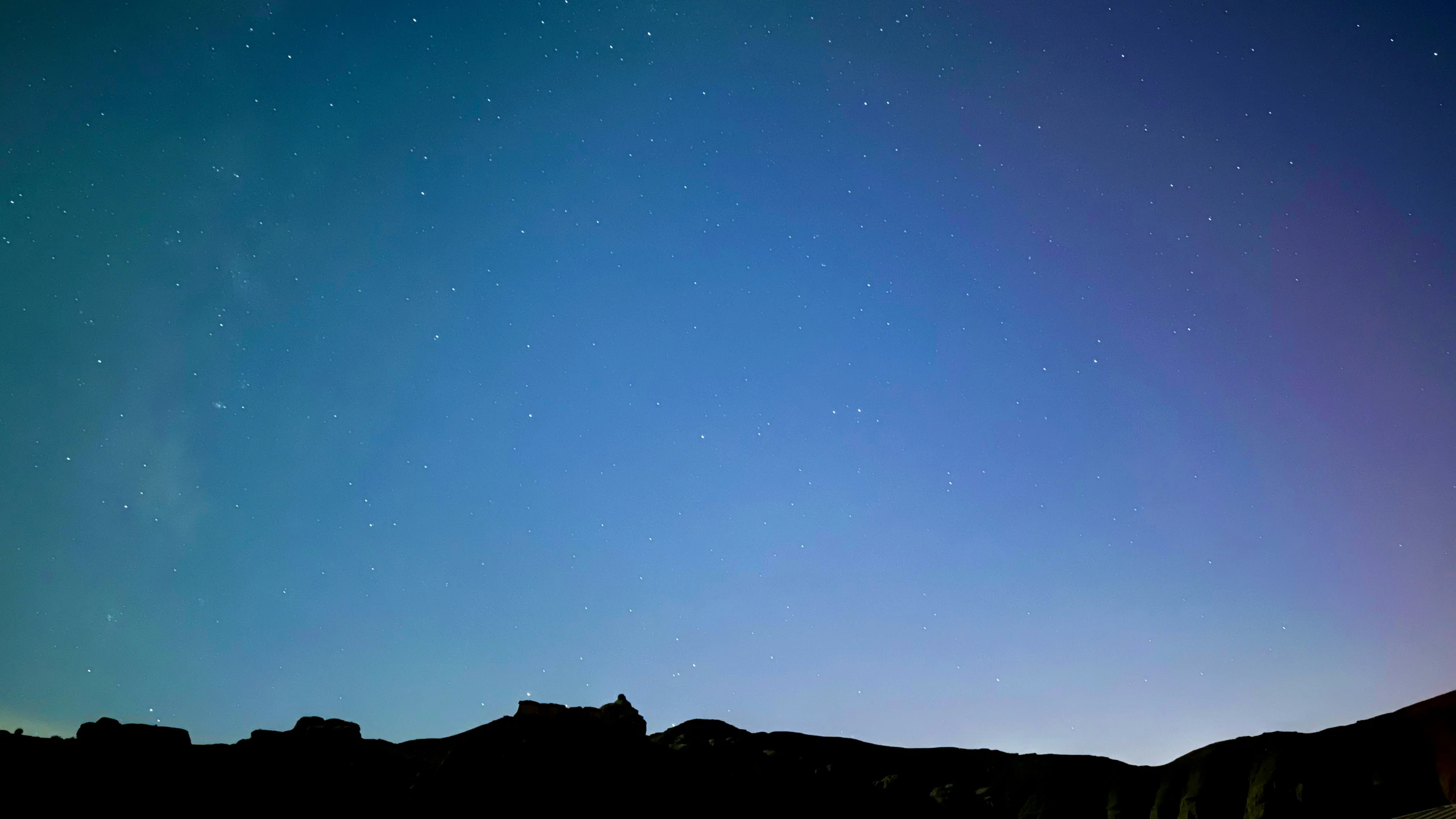 some very pretty stars in the sky above mountains