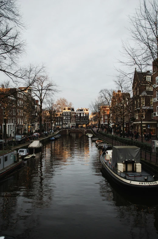 boats are on the river at dusk in an old european town