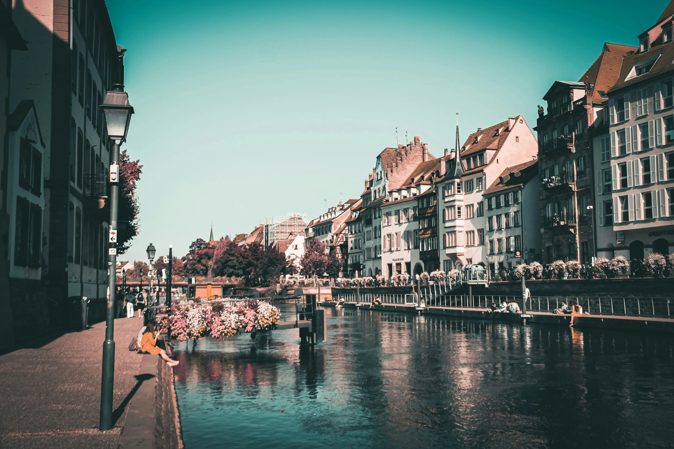 a canal with boats traveling down it next to tall buildings