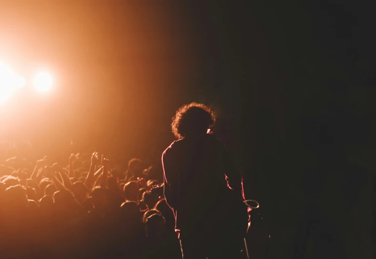 a crowd of people are watching a concert