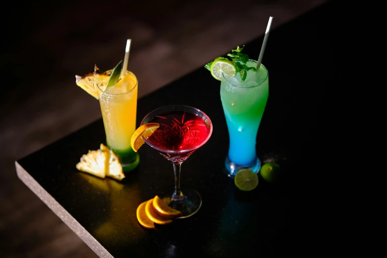 three different cocktails sitting on top of a table