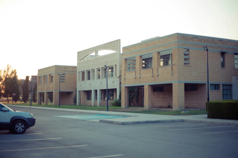 a street scene with a car in front of several brick buildings