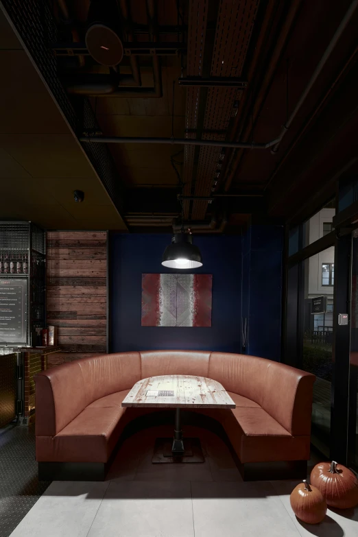 an empty round booth in a dim lit room