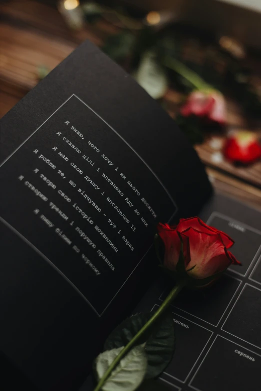an open book with rose and other flowers