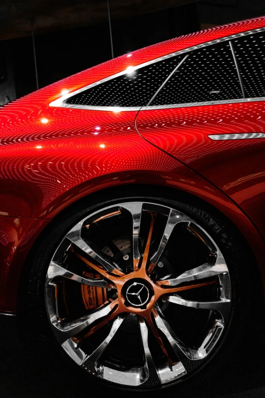 the front wheel view of a red mercedes c class coupe