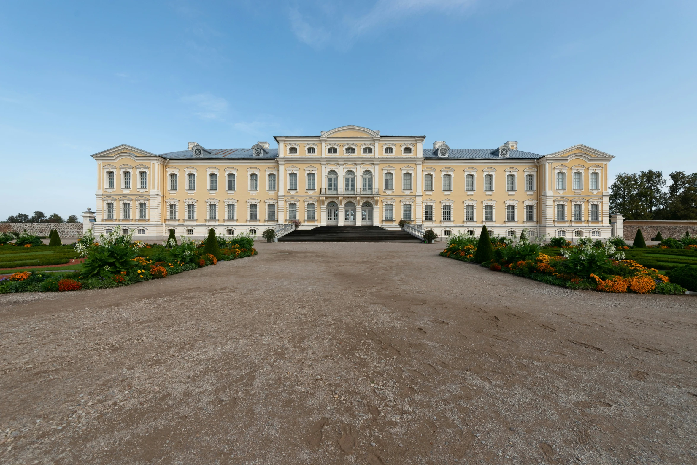 a large mansion with a long driveway in front of it