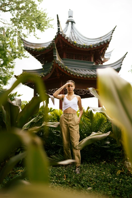 woman standing in front of a structure with a tall wooden roof