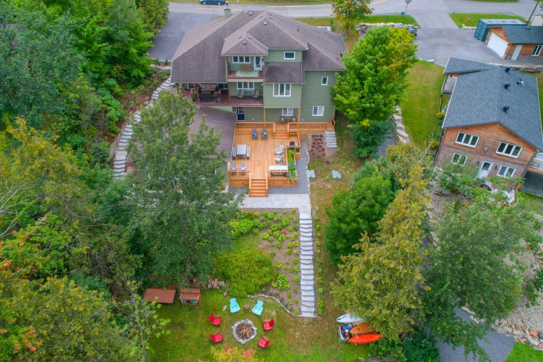 an aerial view of a home and a parking lot in the middle