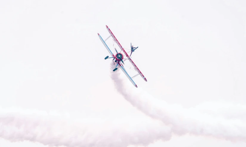 a plane doing stunts that has nozzle behind it