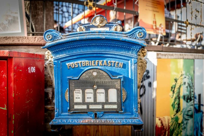 there is an old blue post box in the street