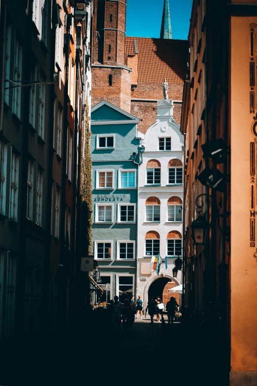 an alley with buildings in europe and a horse pulling a carriage