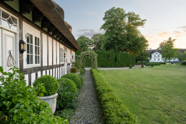 a house sitting on the side of a lush green hill