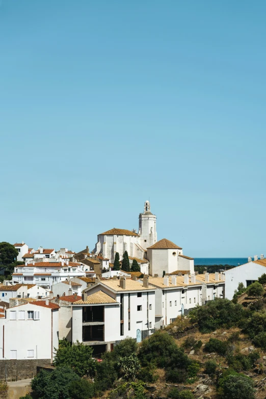 white cityscape and its colorful trees overlooking the ocean