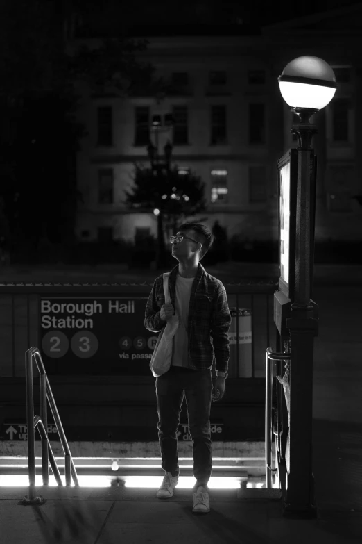 a man standing on the steps next to an outside stairway