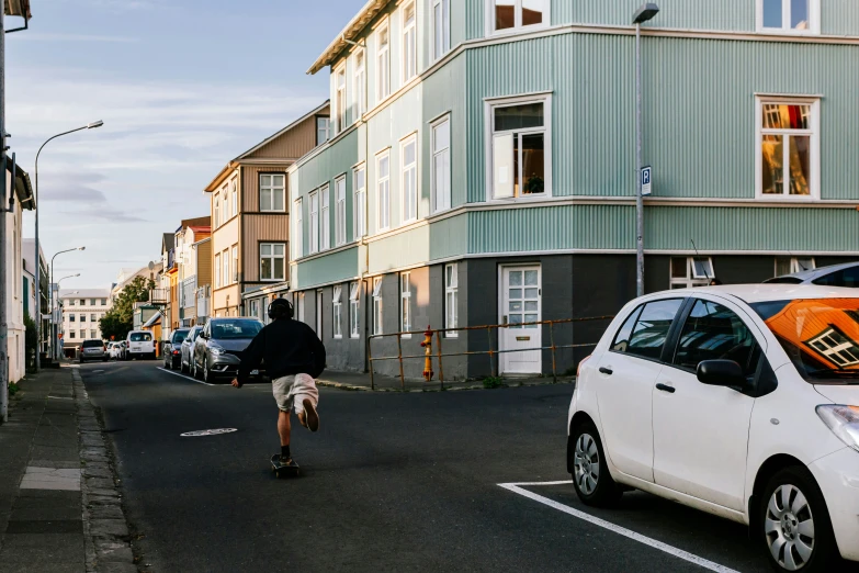 a person rides their bike through a parking lot