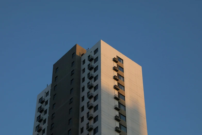 a large building in the city under a blue sky