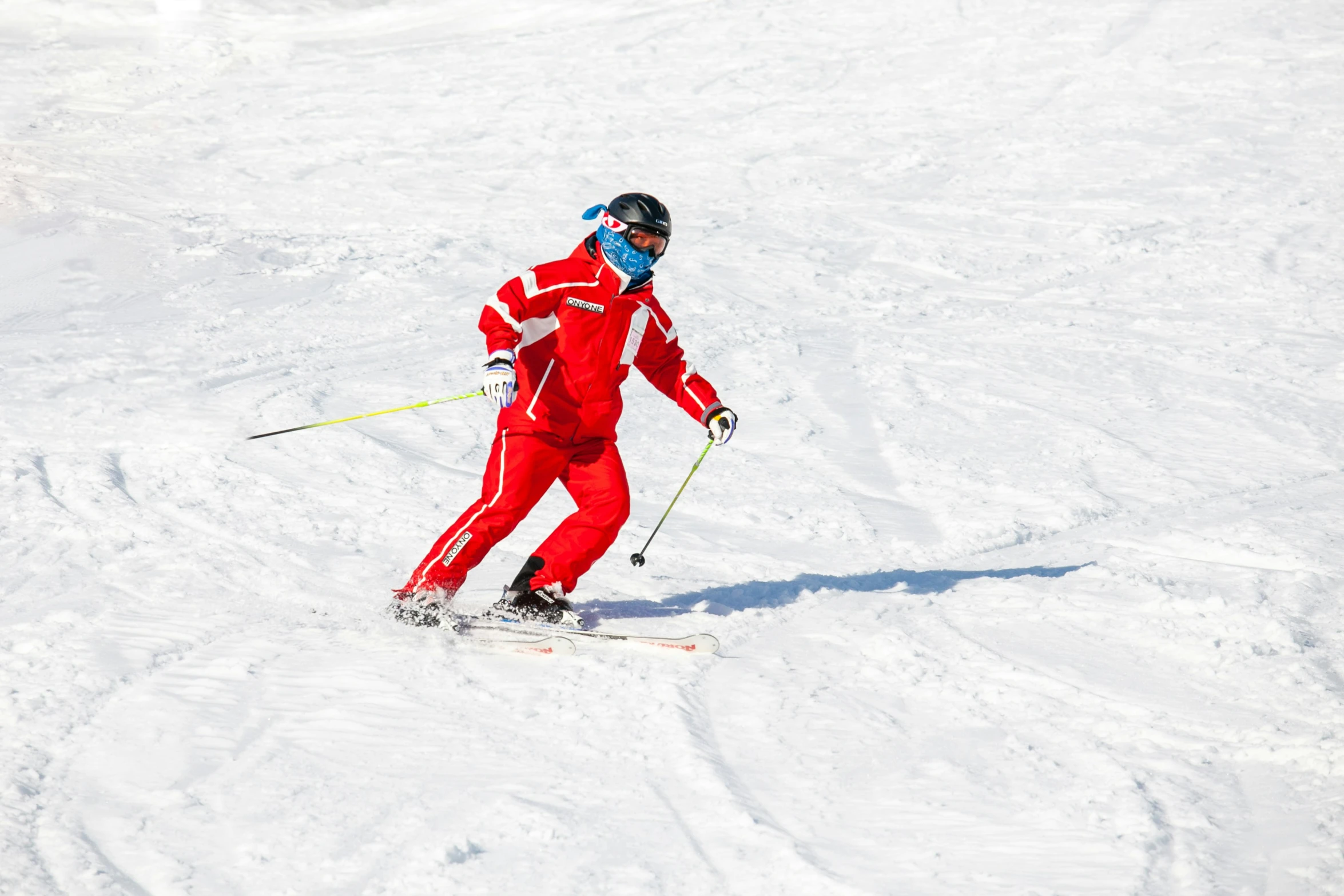 a person on skies downhill on a sunny day