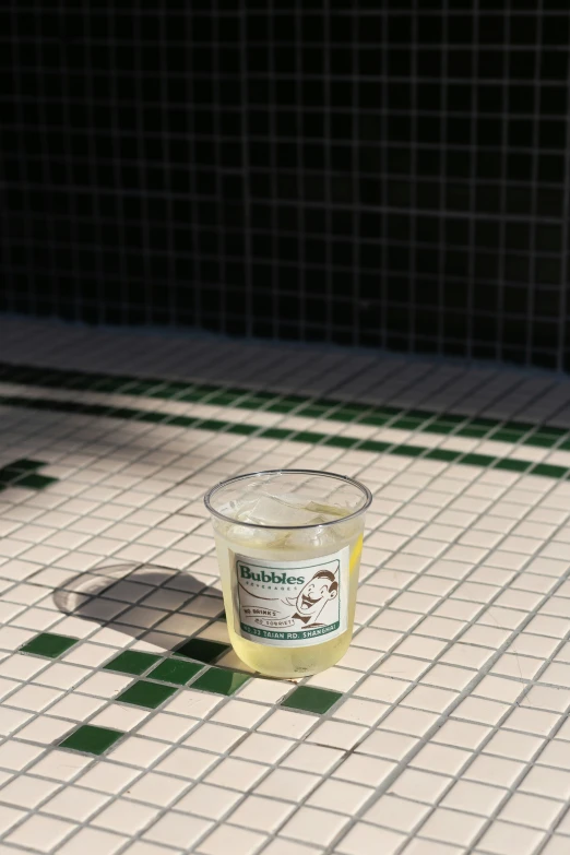 a candle is sitting on a tiled floor