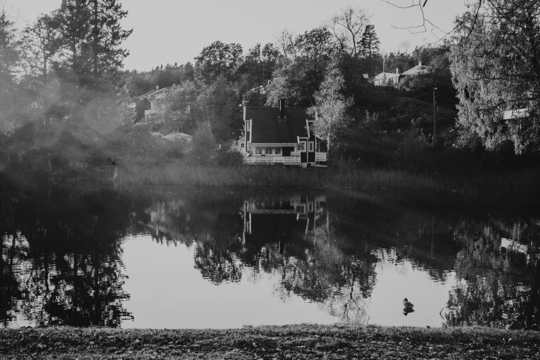 a cabin near the lake on an autumn day