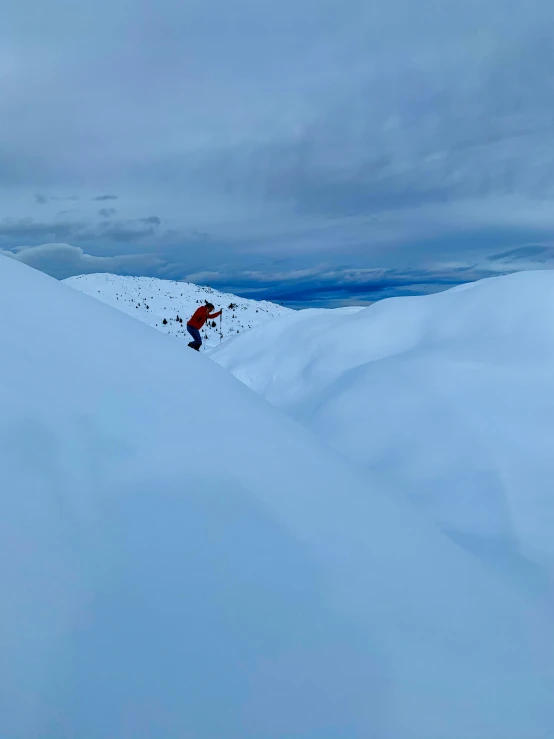 a man riding skis down a snow covered slope