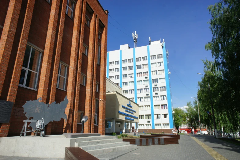 the corner of a city block with a building and some stairs leading to it