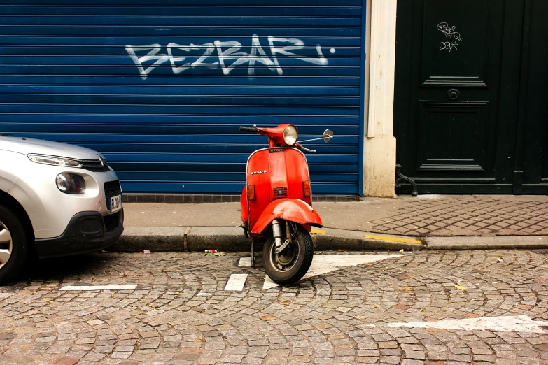 a red motorbike parked on the side of the road