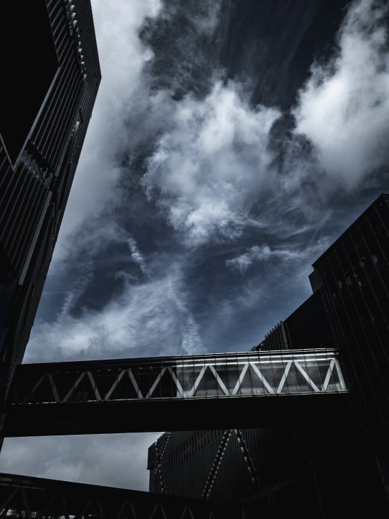 black and white image of clouds and buildings on cloudy day