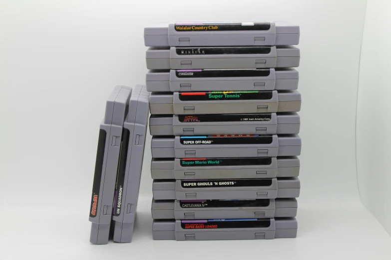 a gray floppy drive stacked on top of another type of game