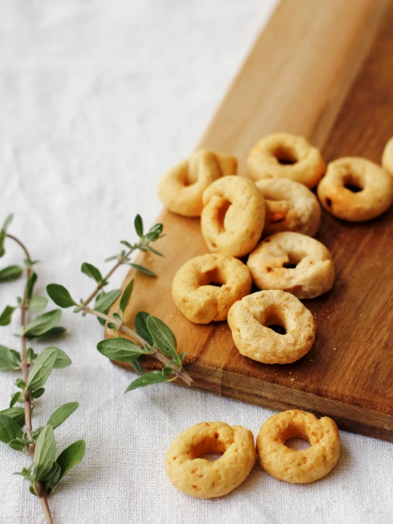 some sugar donuts sit on a  board