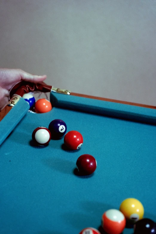 balls being tossed off of a pool table